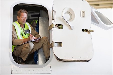 simsearch:649-07238739,k - Aircraft worker checking airplane Stock Photo - Premium Royalty-Free, Code: 649-09002581