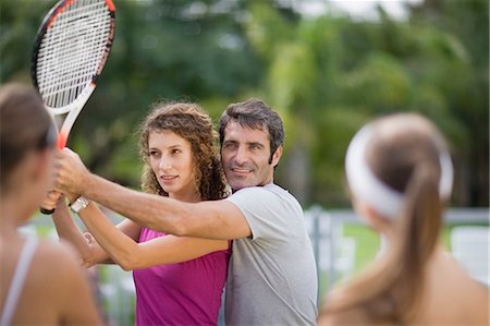 Tennis coach demonstrating with student Foto de stock - Sin royalties Premium, Código: 649-09002602