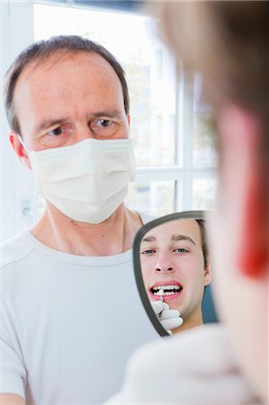 simsearch:649-07280884,k - Dentist showing patient his teeth Foto de stock - Sin royalties Premium, Código: 649-09003469
