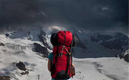 simsearch:614-06625125,k - Backpacker admiring stormy mountains Stock Photo - Premium Royalty-Free, Code: 649-09003683