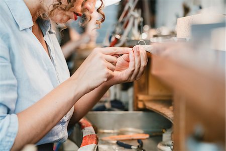 simsearch:6115-07109879,k - Cropped shot of female jeweller shaping silver metal at workbench Stock Photo - Premium Royalty-Free, Code: 649-09016527