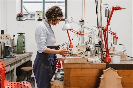 simsearch:6118-08202525,k - Female jeweller using blow torch at workbench Stock Photo - Premium Royalty-Free, Code: 649-09016560