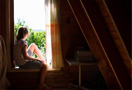 simsearch:649-07239584,k - Teenage girl sitting on bedroom windowsill looking out at sunlight Stock Photo - Premium Royalty-Free, Code: 649-09016599