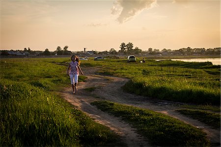 simsearch:649-07239584,k - Lone teenage girl running along rural dirt track at sunset Stock Photo - Premium Royalty-Free, Code: 649-09016611