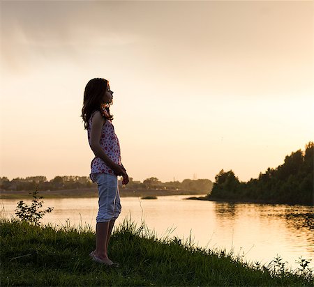 simsearch:649-07239584,k - Teenage girl looking out over river at sunset Stock Photo - Premium Royalty-Free, Code: 649-09016612