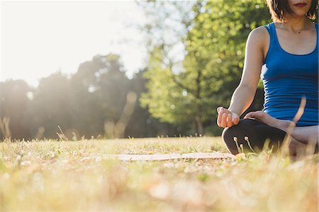 simsearch:614-08065889,k - Mature woman in park, sitting in yoga position, low angle view Stock Photo - Premium Royalty-Free, Code: 649-09025378