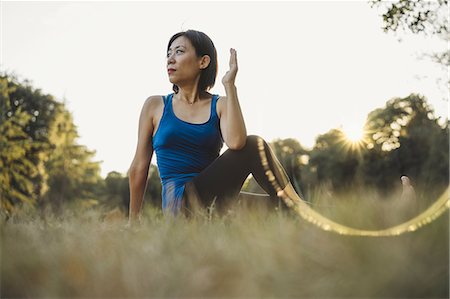 simsearch:614-08065889,k - Mature woman outdoors, sitting in yoga position, low angle view Stock Photo - Premium Royalty-Free, Code: 649-09025372