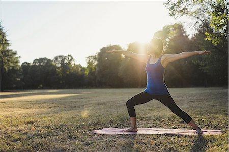 simsearch:614-08065889,k - Mature woman in park, standing in yoga position, arms outstretched Stock Photo - Premium Royalty-Free, Code: 649-09025373