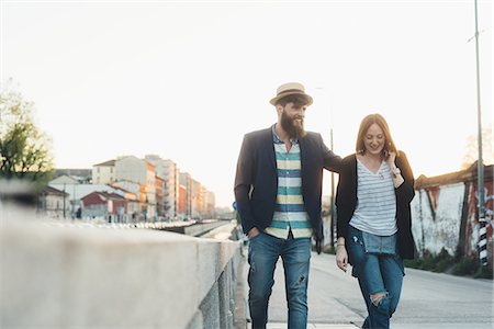 Hipster couple strolling by city canal Stock Photo - Premium Royalty-Free, Code: 649-09025567