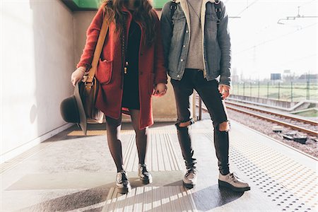 Portrait of young couple on train platform, low section Stock Photo - Premium Royalty-Free, Code: 649-09025636