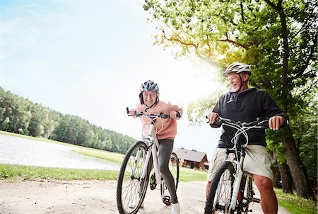 simsearch:649-07438003,k - Mature couple cycling beside lake, laughing, low angle view Stock Photo - Premium Royalty-Free, Code: 649-09025914
