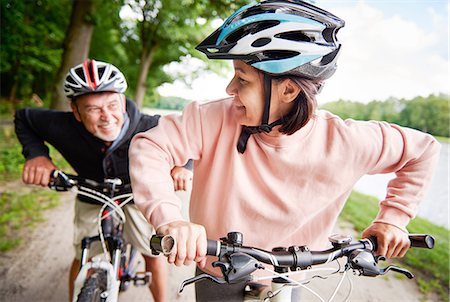 simsearch:649-07438003,k - Mature couple cycling beside lake, laughing Stock Photo - Premium Royalty-Free, Code: 649-09025918