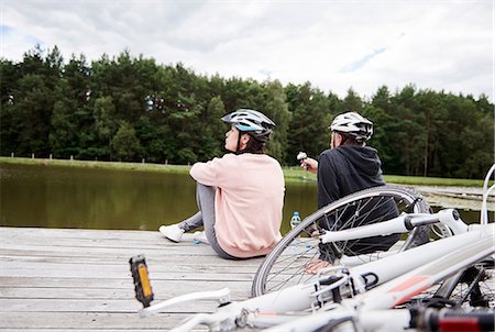 simsearch:649-07438003,k - Mature couple relaxing on jetty, bicycles beside them, rear view Stock Photo - Premium Royalty-Free, Code: 649-09025923