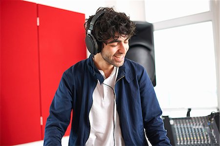 dj - Young male college DJ student listening to music on headphones Stock Photo - Premium Royalty-Free, Code: 649-09026207