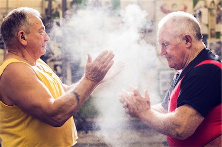simsearch:614-06442313,k - Two senior male powerlifters chalking their hands in gym Stock Photo - Premium Royalty-Free, Code: 649-09035406