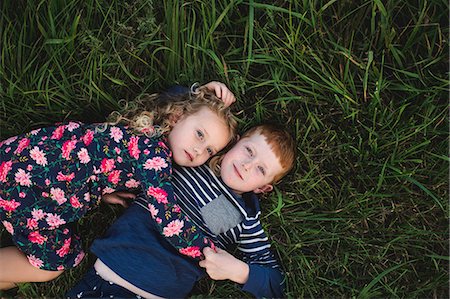 sister brother hugging two - Overhead portrait of boy and sister lying on grass hugging Stock Photo - Premium Royalty-Free, Code: 649-09035531