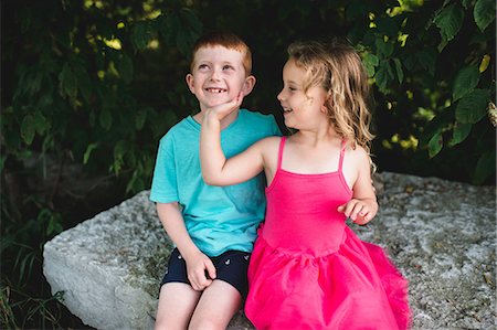 simsearch:614-07806393,k - Girl with hand on brother's chin, sitting on rock Stock Photo - Premium Royalty-Free, Code: 649-09035532