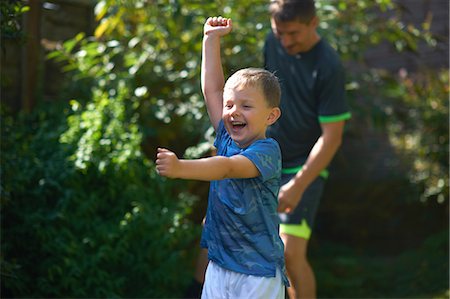 running family grass - Father and son playing in garden Stock Photo - Premium Royalty-Free, Code: 649-09035802