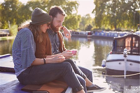 dreaming about eating - Couple eating cupcakes on canal boat Stock Photo - Premium Royalty-Free, Code: 649-09061651