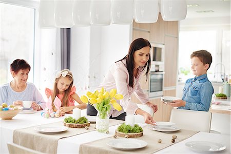 denim shirt - Woman and family preparing place settings at easter dining table Stock Photo - Premium Royalty-Free, Code: 649-09061684