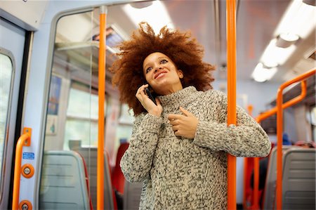 Woman using mobile phone on train, London Stock Photo - Premium Royalty-Free, Code: 649-09078054