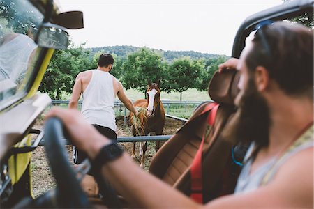 Young man on road trip feeding horse by roadside, Como, Lombardy, Italy Stock Photo - Premium Royalty-Free, Code: 649-09078284