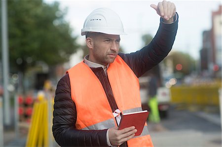 Road engineer signalling with hand and holding digital tablet Stock Photo - Premium Royalty-Free, Code: 649-09078325