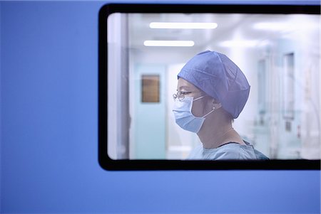 Window view of two female surgeon in maternity ward operating theatre Stock Photo - Premium Royalty-Free, Code: 649-09078374