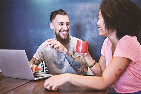 Multi ethnic hipster couple in cafe using laptop, Shanghai French Concession, Shanghai, China Stock Photo - Premium Royalty-Free, Code: 649-09078400