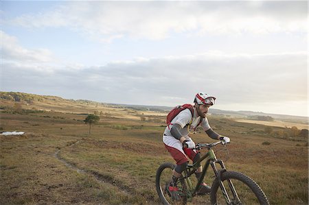 person tshirt rucksack - Male mountain biker biking up moorland track Stock Photo - Premium Royalty-Free, Code: 649-09078444