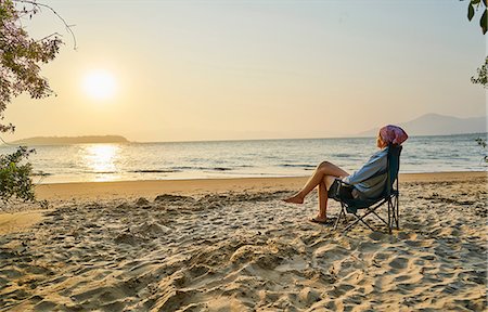 simsearch:649-09078617,k - Woman on beach in deckchair looking away at sea, Florianopolis, Santa Catarina, Brazil, South America Stock Photo - Premium Royalty-Free, Code: 649-09078623