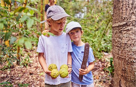 Boys in jungle holding coconuts and seed, Aguas Calientes, Chuquisaca, Bolivia, South America Stock Photo - Premium Royalty-Free, Code: 649-09078641