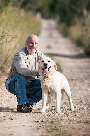 simsearch:400-05724021,k - Portrait of senior man crouching beside pet dog Stock Photo - Premium Royalty-Free, Code: 649-09111184