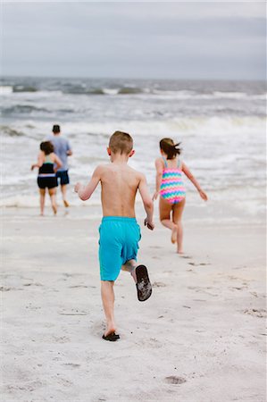 simsearch:649-06352471,k - Man and children running toward sea from beach, rear view, Dauphin Island, Alabama, USA Stock Photo - Premium Royalty-Free, Code: 649-09124037