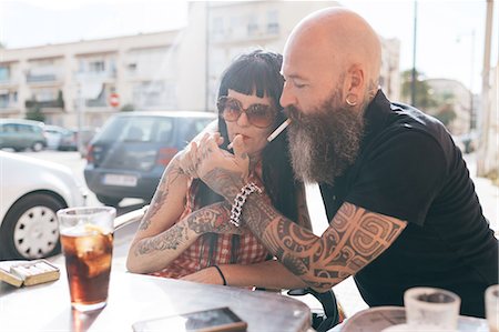 simsearch:632-07539963,k - Mature hipster couple lighting cigarette at sidewalk cafe, Valencia, Spain Stock Photo - Premium Royalty-Free, Code: 649-09123448