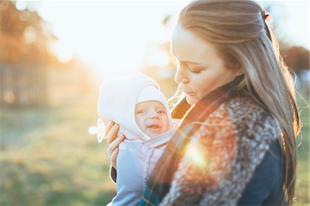 simsearch:859-06808650,k - Mother and baby daughter outdoors, mother carrying baby in baby sling Stock Photo - Premium Royalty-Free, Code: 649-09123526