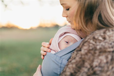 simsearch:859-06808650,k - Mother and baby daughter outdoors, mother carrying baby in baby sling Stock Photo - Premium Royalty-Free, Code: 649-09123529