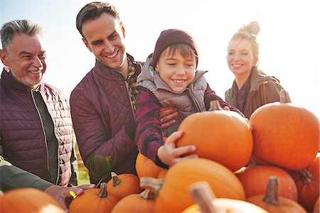 farm images of happy people - Boy with parents and grandfather selecting pumpkins in pumpkin patch field Stock Photo - Premium Royalty-Free, Code: 649-09123604