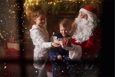 simsearch:640-03260410,k - Young girl and boy receiving gifts from Santa Claus Stock Photo - Premium Royalty-Free, Code: 649-09123668
