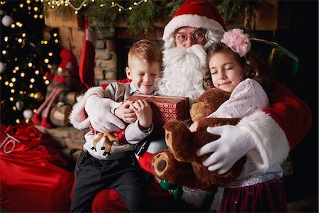 simsearch:640-03260410,k - Young girl and boy visiting Santa, holding gifts Stock Photo - Premium Royalty-Free, Code: 649-09123661