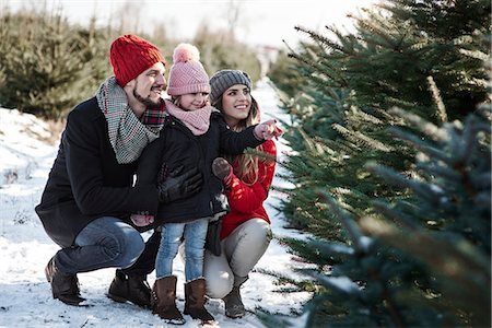 snow christmas tree white - Girl and parents looking at forest christmas trees Stock Photo - Premium Royalty-Free, Code: 649-09123777