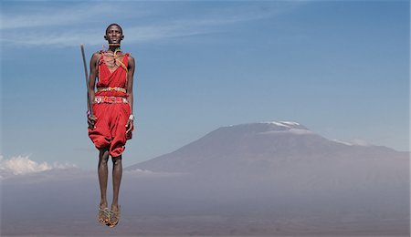 Masai man with traditional dress jumping in front of Mount Kilimanjaro, Amboseli, Rift Valley, Kenya Stock Photo - Premium Royalty-Free, Code: 649-09123937