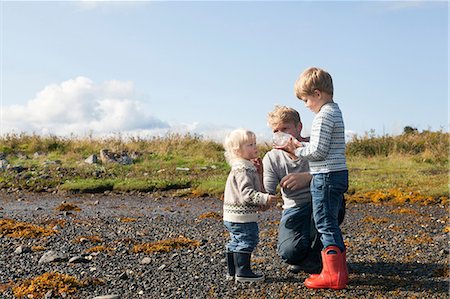 simsearch:649-07437107,k - Man with son looking in bottle on beach, Aure, More og Romsdal, Norway Stock Photo - Premium Royalty-Free, Code: 649-09138976