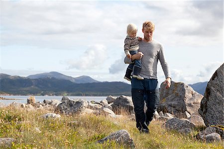 simsearch:649-07437107,k - Man carrying son by fjord, Aure, More og Romsdal, Norway Stock Photo - Premium Royalty-Free, Code: 649-09138970