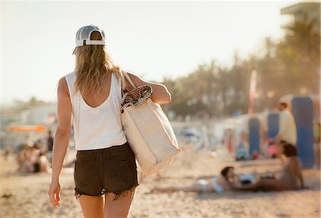 Woman walking along  beach, rear view, Sitges, Catalonia, Spain Stock Photo - Premium Royalty-Free, Code: 649-09139174