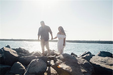 simsearch:649-08239088,k - Couple walking on coastal rocks, holding hands, Seal Beach, California, USA Stock Photo - Premium Royalty-Free, Code: 649-09139193