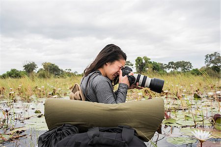 Young female tourist photographing Okavango Delta, Botswana, Africa Stock Photo - Premium Royalty-Free, Code: 649-09156179