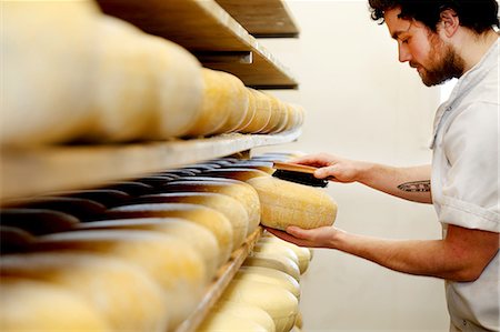 simsearch:649-06164558,k - Cheese maker brushing mould off the hard cheeses by hand Photographie de stock - Premium Libres de Droits, Code: 649-09156382