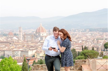 simsearch:649-07560084,k - Young couple smiling at mobile phone, Santa Maria del Fiore in background, Florence, Toscana, Italy Stock Photo - Premium Royalty-Free, Code: 649-09159125