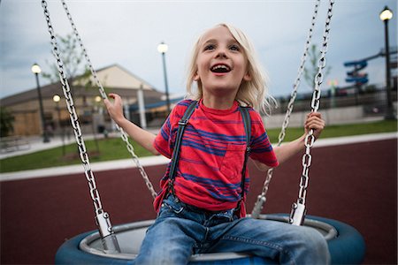 simsearch:649-07647801,k - Boy playing on swing in playground Stock Photo - Premium Royalty-Free, Code: 649-09159484
